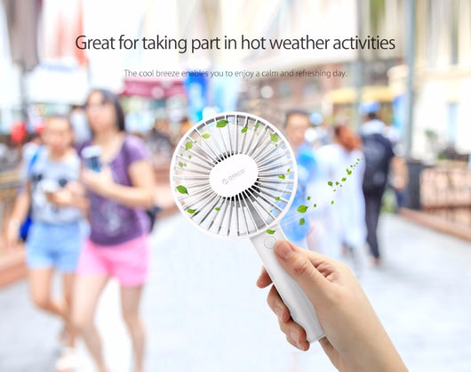White ORICO FH1 handheld USB fan with charging dock, USB cable, and user manuals on a wooden desk. - Image 13