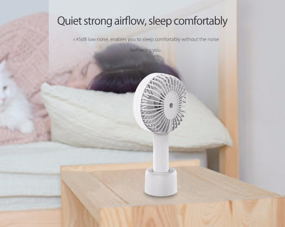 White ORICO FH1 handheld USB fan with charging dock, USB cable, and user manuals on a wooden desk. - Image 15