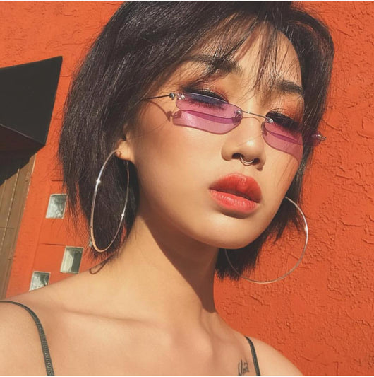 Rimless trendy sunglasses with rectangular orange lenses and gold-tone metal frames, featuring black temple tips. - Image 12