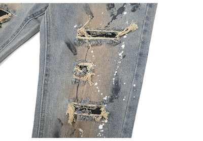 Jeans Rotos con Detalles de Tinta y Parches Desgastados - Image 13