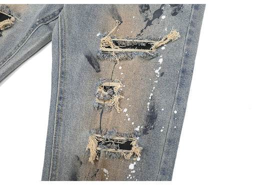 Jeans Rotos con Detalles de Tinta y Parches Desgastados - Image 13