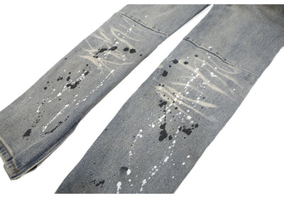 Jeans Rotos con Detalles de Tinta y Parches Desgastados - Image 18