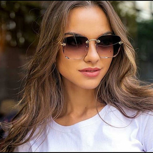 Pink rimless square sunglasses with wavy edges, gold-tone hardware, and clear pink temples on a white background. - Image 5