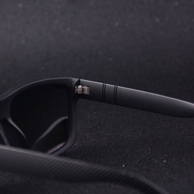 Men's grey plastic frame driving sunglasses with dark polarized lenses and red and black stripe detail on temples. - Image 22