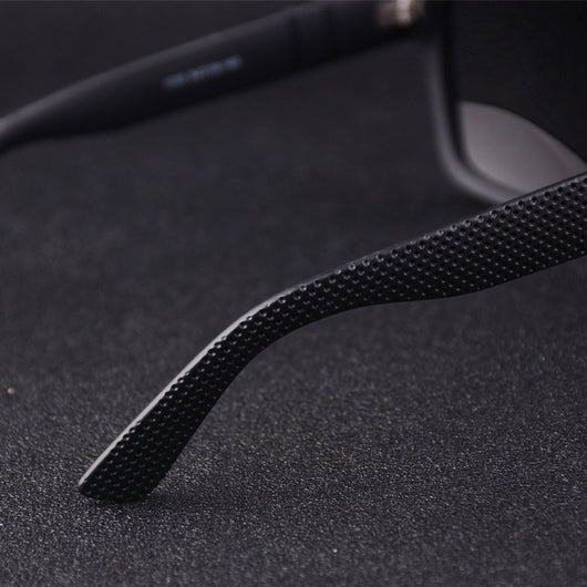 Men's grey plastic frame driving sunglasses with dark polarized lenses and red and black stripe detail on temples. - Image 24