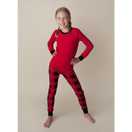 Family of four wearing matching red and black buffalo plaid Christmas pajamas, featuring solid red long-sleeve tops and plaid pants. - Image 13