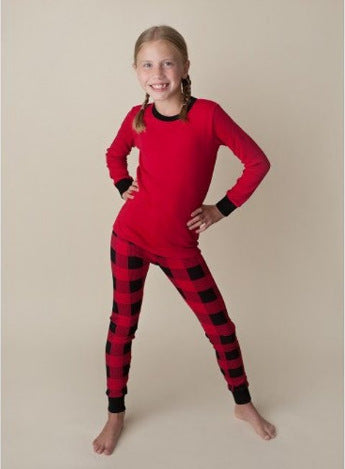 Family of four wearing matching red and black buffalo plaid Christmas pajamas, featuring solid red long-sleeve tops and plaid pants. - Image 17