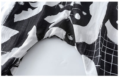 Girls' two-piece outfit with a black sleeveless top and black and white camouflage wide-leg suspender pants. - Image 13