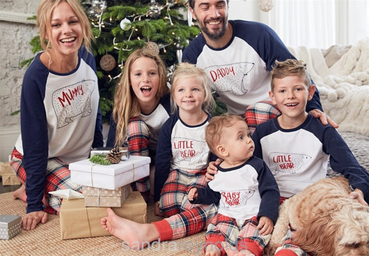Family of four wearing matching Christmas pajamas with white and navy bear print tops and red plaid pants. - Image 9