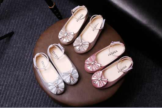 Shiny pink children's ballet flats with ankle straps, decorative bows, and rhinestone embellishments. - Image 7