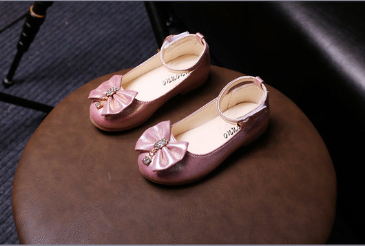 Shiny pink children's ballet flats with ankle straps, decorative bows, and rhinestone embellishments. - Image 8