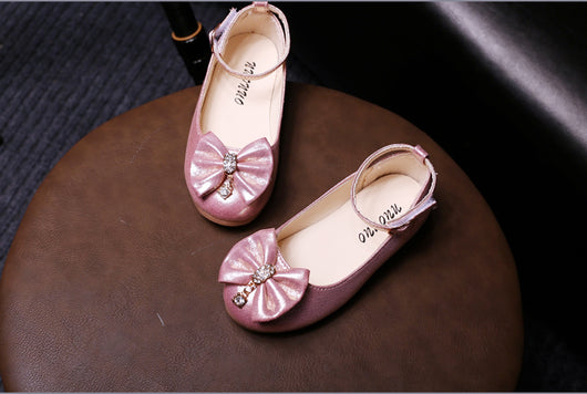 Shiny pink children's ballet flats with ankle straps, decorative bows, and rhinestone embellishments. - Image 9