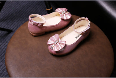 Shiny pink children's ballet flats with ankle straps, decorative bows, and rhinestone embellishments. - Image 10
