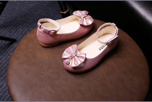Shiny pink children's ballet flats with ankle straps, decorative bows, and rhinestone embellishments. - Image 10