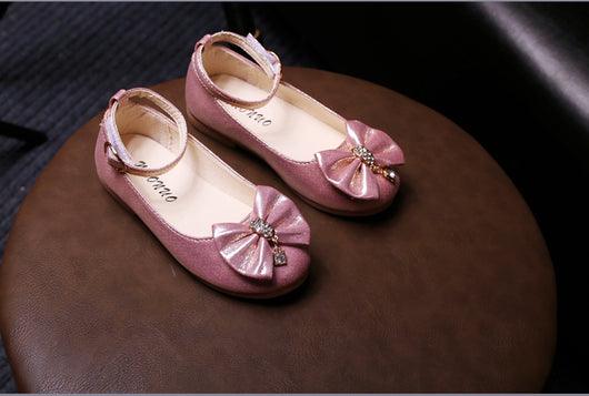 Shiny pink children's ballet flats with ankle straps, decorative bows, and rhinestone embellishments. - Image 11