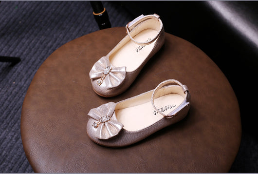 Shiny pink children's ballet flats with ankle straps, decorative bows, and rhinestone embellishments. - Image 12