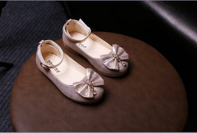 Shiny pink children's ballet flats with ankle straps, decorative bows, and rhinestone embellishments. - Image 13
