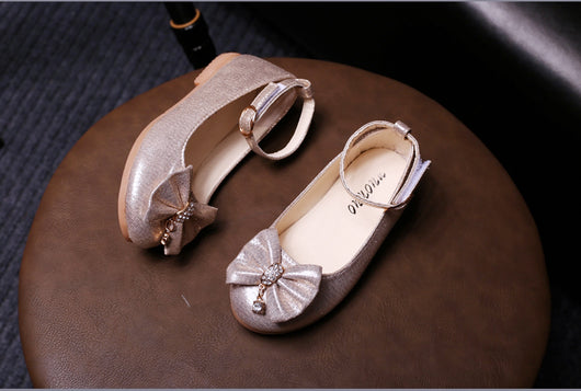 Shiny pink children's ballet flats with ankle straps, decorative bows, and rhinestone embellishments. - Image 14