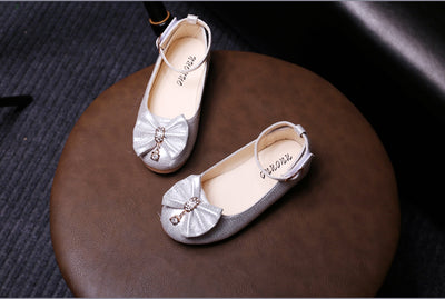 Shiny pink children's ballet flats with ankle straps, decorative bows, and rhinestone embellishments. - Image 15