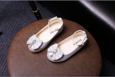 Shiny pink children's ballet flats with ankle straps, decorative bows, and rhinestone embellishments. - Image 16