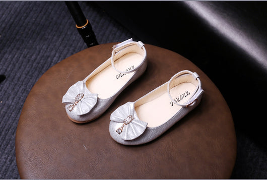 Shiny pink children's ballet flats with ankle straps, decorative bows, and rhinestone embellishments. - Image 16