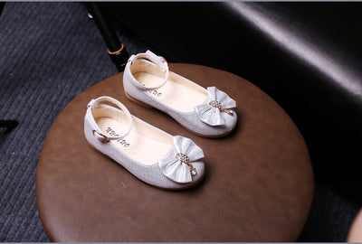 Shiny pink children's ballet flats with ankle straps, decorative bows, and rhinestone embellishments. - Image 17