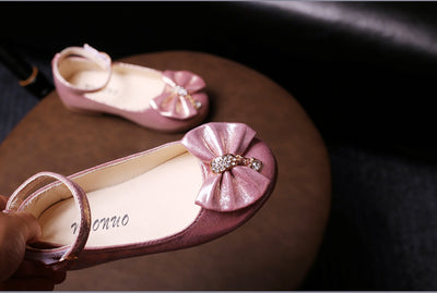 Shiny pink children's ballet flats with ankle straps, decorative bows, and rhinestone embellishments. - Image 18