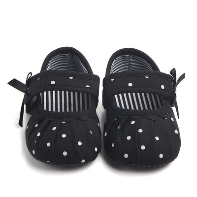 Black baby girl Mary Jane shoes with white polka dots, a strap, bow accent, and striped lining. - Image 8