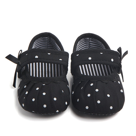 Black baby girl Mary Jane shoes with white polka dots, a strap, bow accent, and striped lining. - Image 8