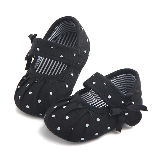 Black baby girl Mary Jane shoes with white polka dots, a strap, bow accent, and striped lining. - Image 9