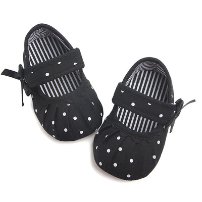 Black baby girl Mary Jane shoes with white polka dots, a strap, bow accent, and striped lining. - Image 10