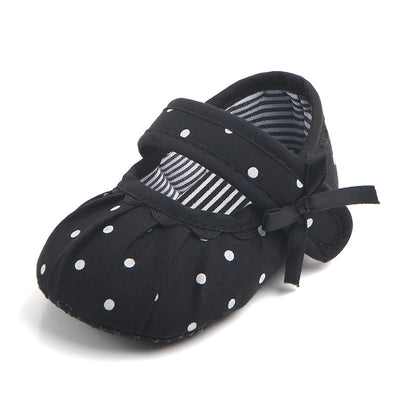 Black baby girl Mary Jane shoes with white polka dots, a strap, bow accent, and striped lining. - Image 12