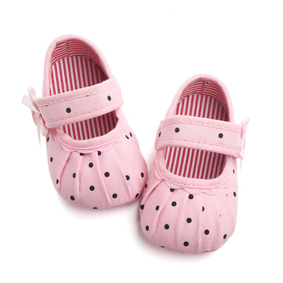 Black baby girl Mary Jane shoes with white polka dots, a strap, bow accent, and striped lining. - Image 14