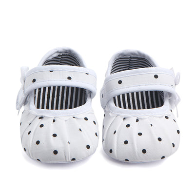 Black baby girl Mary Jane shoes with white polka dots, a strap, bow accent, and striped lining. - Image 18