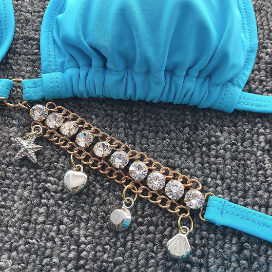 Turquoise triangle bikini with gold-toned rhinestone chain halter straps and matching charm-embellished waistline. - Image 15