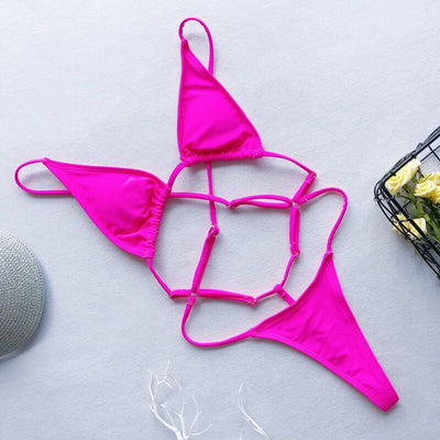 Red one-piece swimsuit with a strappy cut-out design, triangle top, and thong bottom, laid flat. - Image 11