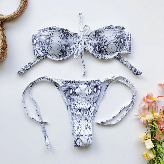 Light pink ribbed bikini set with a strapless ruffled top and high-cut, tie-side bottom on a model. - Image 14