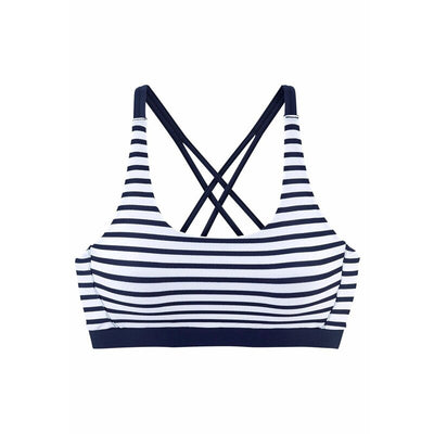 Woman smiling on a beach wearing a navy and white striped two-piece bikini with a racerback top. - Image 9