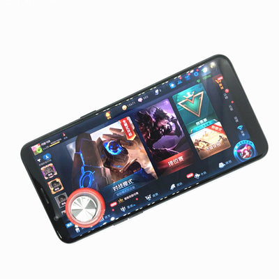 Pink and silver mobile game joystick attached to a black smartphone displaying a game on its screen. - Image 6