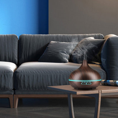Wood grain ultrasonic aromatherapy diffuser and humidifier with a glowing blue LED light band and control buttons. - Image 10