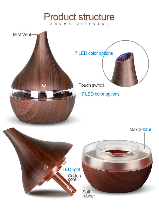 Dark wood grain LED essential oil diffuser with a blue light band and touch switch, shown with a hand operating it. Includes a bundle of 10 white filter sticks. - Image 14