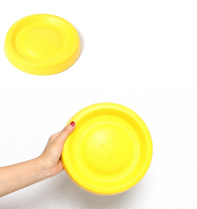 Bright yellow EVA pet ball dog toy with textured grooves and paw print details for interactive play. - Image 21
