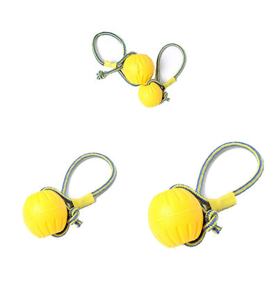 Bright yellow EVA pet ball dog toy with textured grooves and paw print details for interactive play. - Image 22