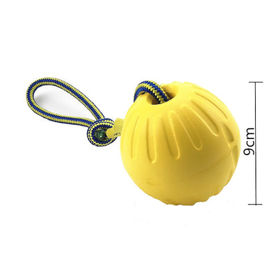 Bright yellow EVA pet ball dog toy with textured grooves and paw print details for interactive play. - Image 23