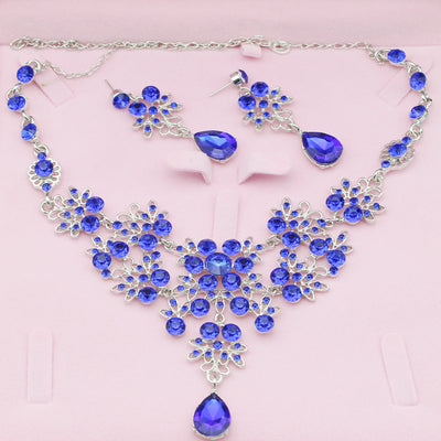 Purple crystal necklace and earring set with butterfly and floral designs, featuring large teardrop pendants. - Image 6