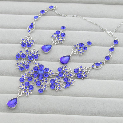 Purple crystal necklace and earring set with butterfly and floral designs, featuring large teardrop pendants. - Image 7