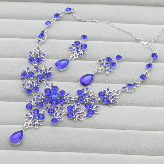 Purple crystal necklace and earring set with butterfly and floral designs, featuring large teardrop pendants. - Image 7