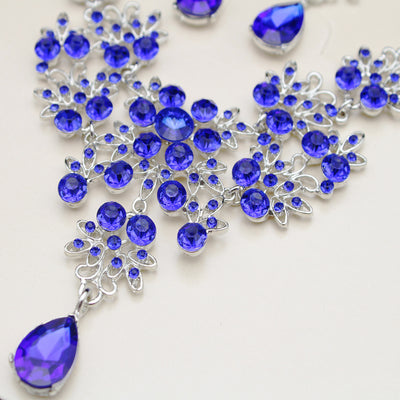 Purple crystal necklace and earring set with butterfly and floral designs, featuring large teardrop pendants. - Image 9