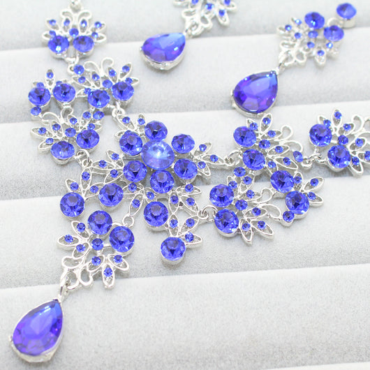 Purple crystal necklace and earring set with butterfly and floral designs, featuring large teardrop pendants. - Image 12
