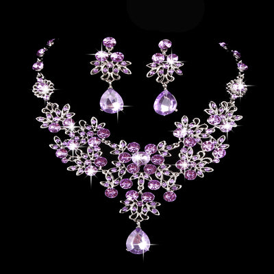 Purple crystal necklace and earring set with butterfly and floral designs, featuring large teardrop pendants. - Image 25